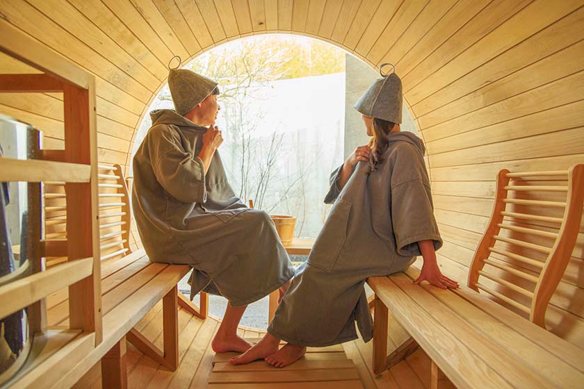 Couple enjoying sauna in barrel sauna