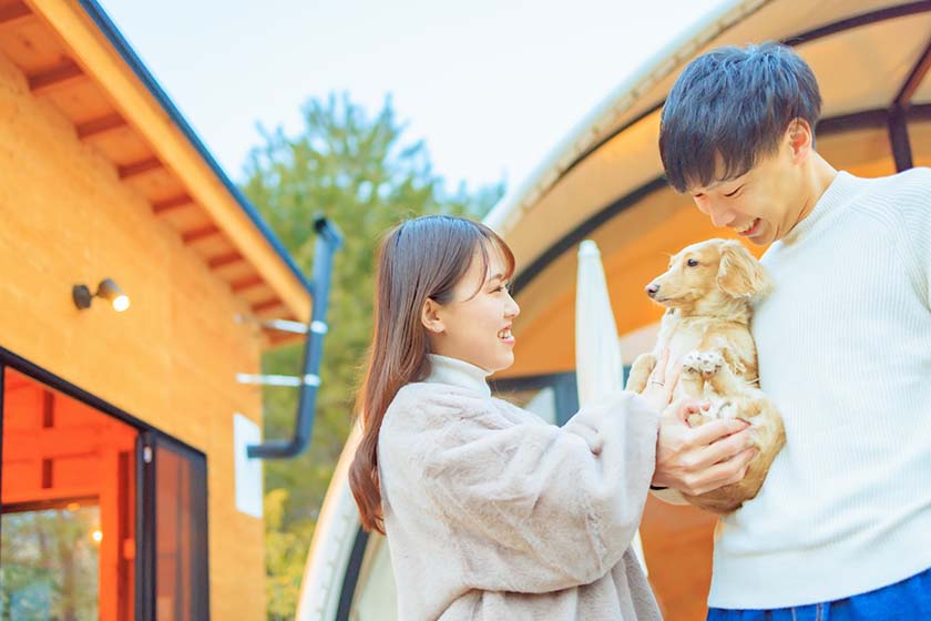 A couple celebrating their dog at a glamping facility